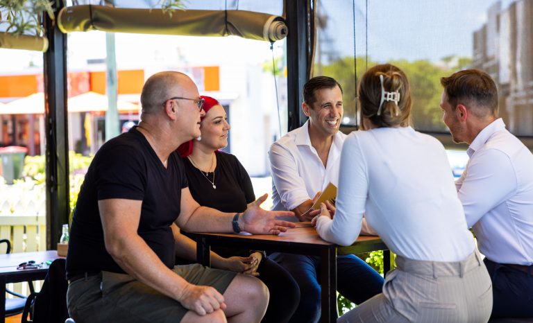 people in a business meeting seated at a table